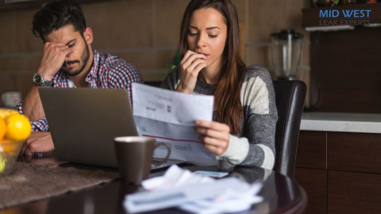 a couple reading a high water bill