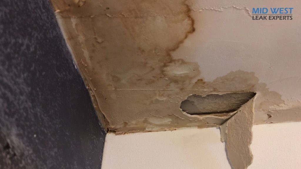 water damage in a bathroom with mold on the wall casued by a hidden water leak