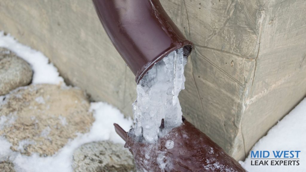 a broken pipe with ice coming out of it
